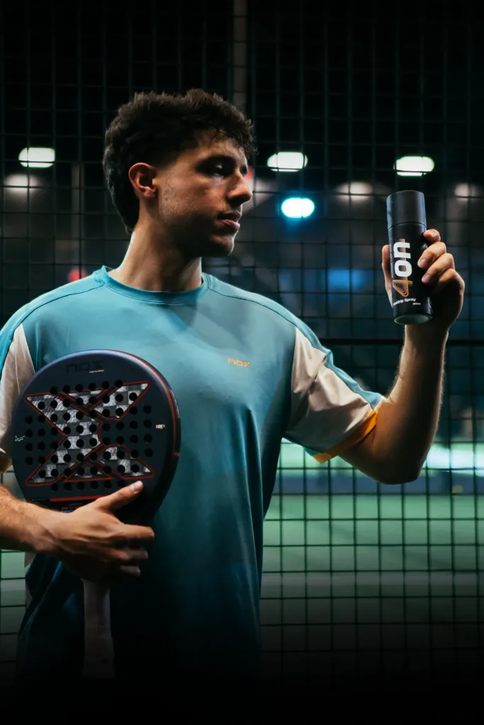 Pro padel player Agustín Tapia holding a 4on TotalGrip spray