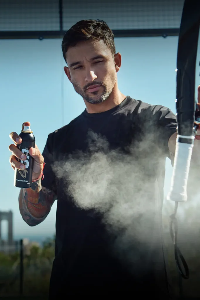 Pro padel player Daniel Sanyo Gutierrez spraying 4on TotalGrip on his racket